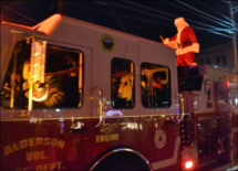 Santa makes his grand entrance on the fire truck.