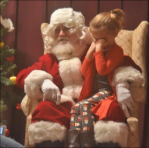 This little girl was way too shy to tell Santa her Christmas wishes.
