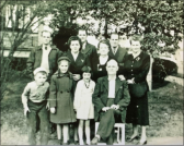  (a) back row, left to right: Finley Russell, Andrew J. Russell and Jim Russell; (b) middle row, left to right:  Drema Russell Gwinn, Essie Russell and Glenna Russell Grose; (c) front row:  Andy Russell, Joanie Gwinn, Nancy Russell and A. S. Russell.