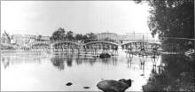 1914 - The year Alderson had three bridges, in one place. Visable, the iron bridge being used as scafolding for new cement bridge (note arches). Wooden foot bridge.