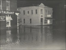 Water in the streets. (Date not known) Taken at the corner of Monroe and Riverview, at the end of bridge. White bulding is Hanger Jewelry Store which is no longer there.